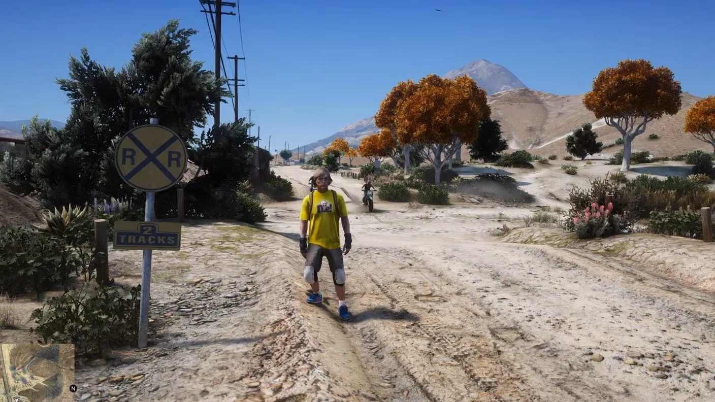 FiveM without the menu: a dirt road, the second player on the motorbike barely visible in the distance